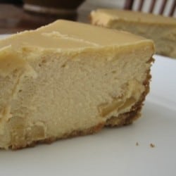 Slice of brown sugar apple cheesecake on a white plate.