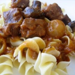 Pasta noodles topped with beef burgundy sauce, pearl onions, and beef.