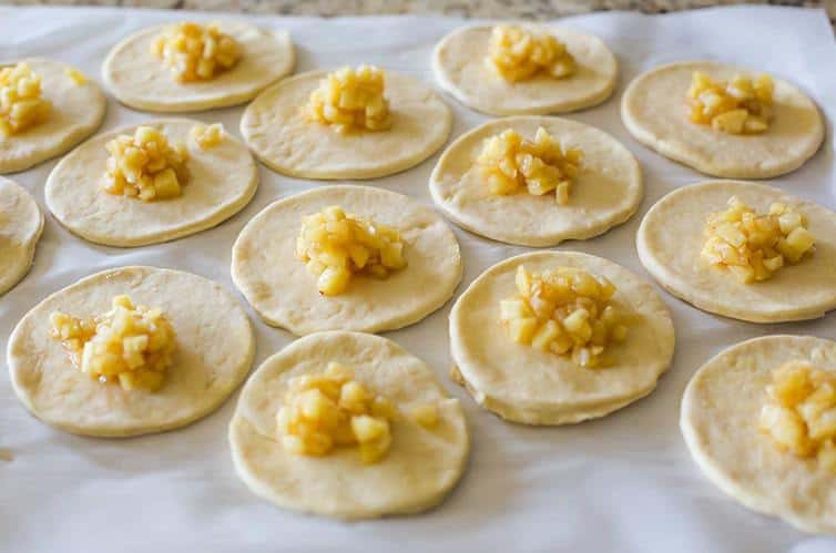 Dough circles topped with apple filling for Apple Hand Pies