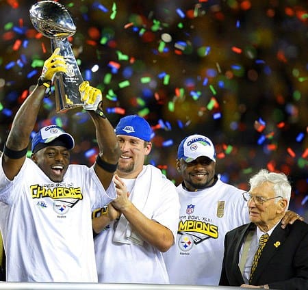 Pittsburgh Steelers players holding Super Bowl trophy.