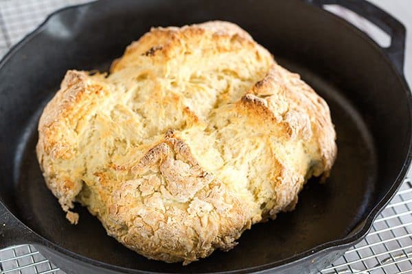Classic Irish Soda Bread - Takes less than 10 minutes to mix together! Grab a slice warm from the oven and slather it in butter for St. Patrick's Day breakfast!