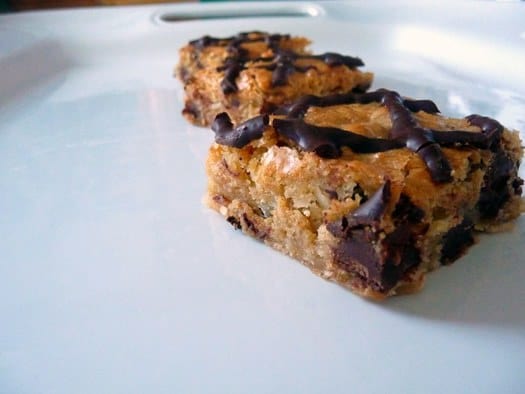 Coconut chocolate chunk blondies on a white plate.