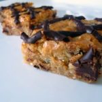 Coconut chocolate chunk blondies on a white plate.