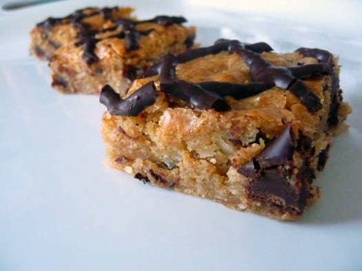 Coconut chocolate chunk blondies on a white plate.
