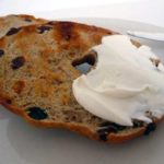 Cinnamon raisin bagel cut in half with cream cheese.