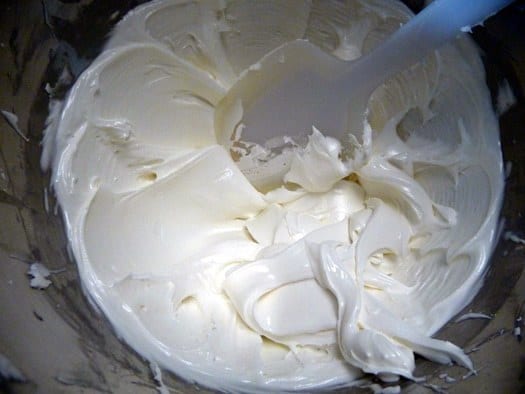 Royal icing in a bowl with a spatula.