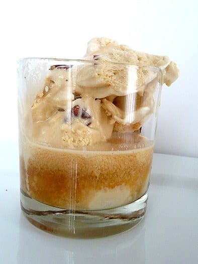 Butter pecan bourbon ice cream float in a clear glass.
