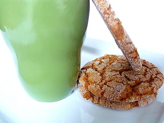 Ginger cookies on a white plate with a green cup.