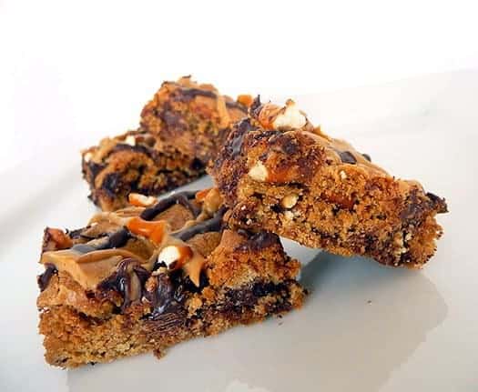 Chocolate chip & pretzel cookie bars on a white plate.