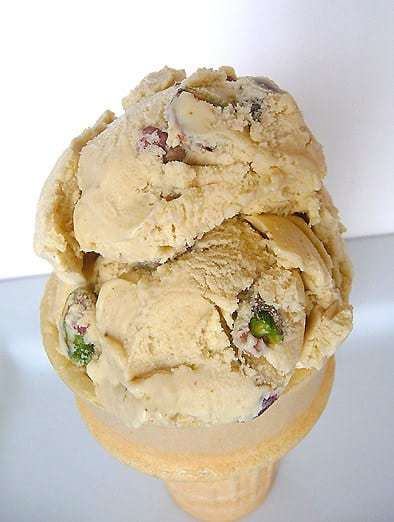 2 scoops of pistachio nut ice cream in an ice cream cone.