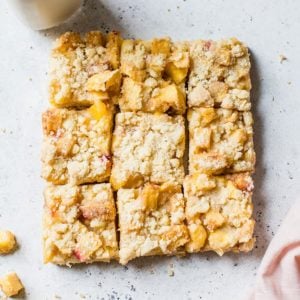 Peach crumb bars cut into nine squares.