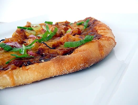 BBQ chicken pizza on a white plate.