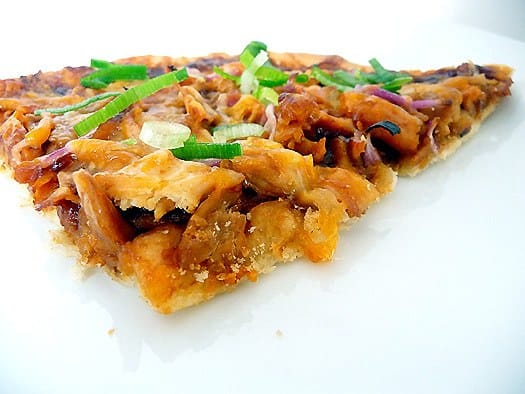 Slice of BBQ chicken pizza on a white plate.