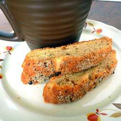 2 pieces of Parmesan black pepper biscotti on a white plate.