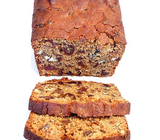 Slices of date nut spice bread on a white plate.