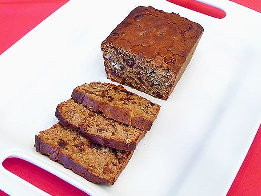Slices of date nut spice bread on a white plate.