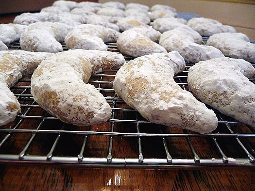 Nut crescent cookies on a cooling rack.