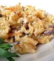 Mushroom and herb macaroni and cheese on a white plate.