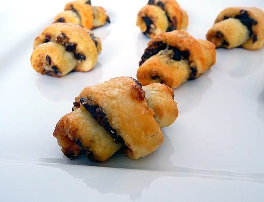 Rugelach cookies on a white plate.