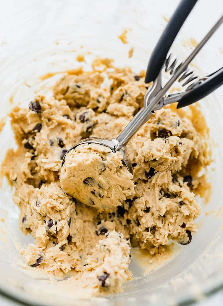 Scooping out the dough for peanut butter-oatmeal chocolate chip cookies.