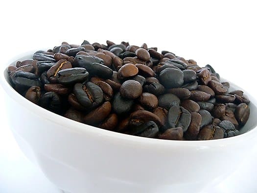 Espresso beans in a white bowl.
