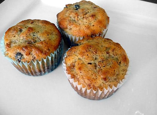 3 Raisin Bran muffins on a white plate.