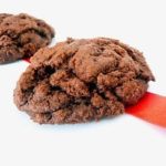 2 triple chocolate cookies on a white plate.