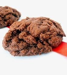 2 triple chocolate cookies on a white plate.