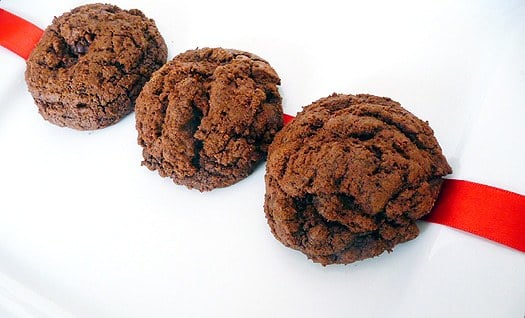 3 triple chocolate cookies on a white plate.