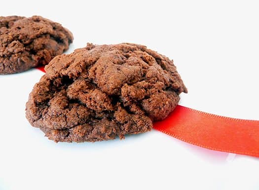 2 triple chocolate cookies on a white plate.