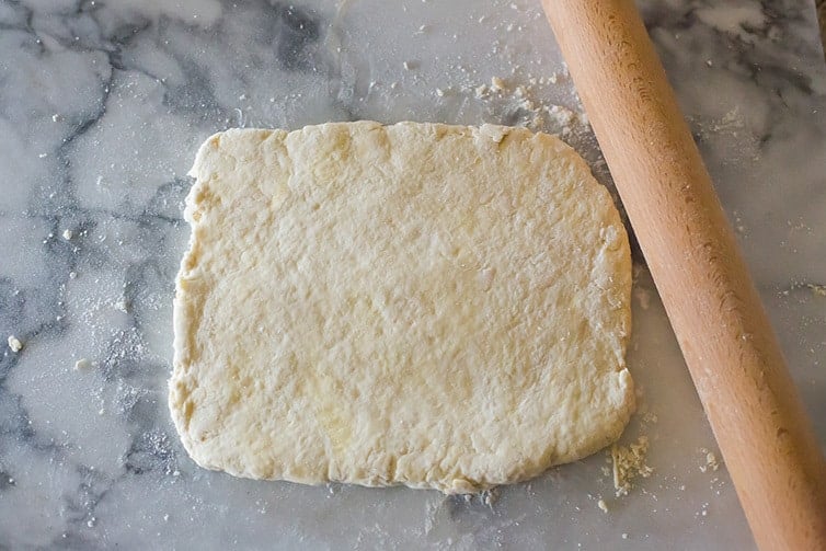 Buttermilk biscuit dough rolled into a rectangle before cutting.