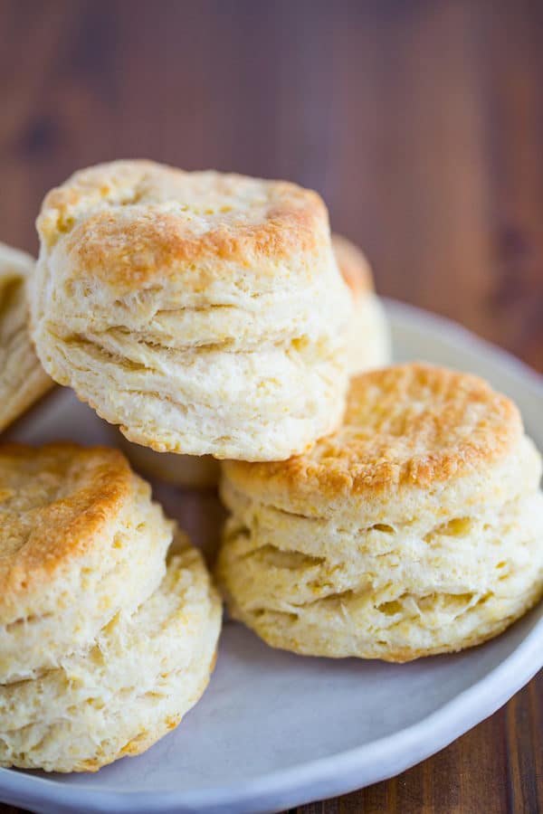 A plate of buttermilk biscuits stacked together.
