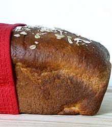 Side view of a loaf of honey oatmeal sandwich bread.