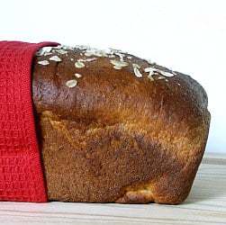 Side view of a loaf of honey oatmeal sandwich bread.