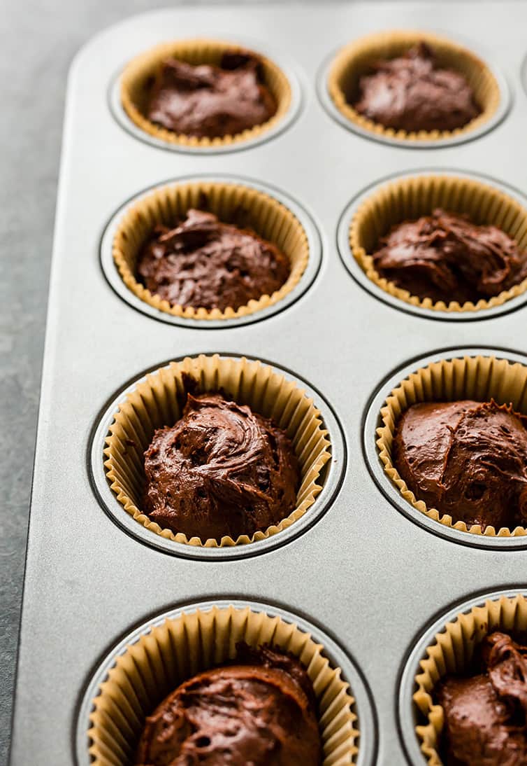 Chocolate cupcake batter in muffin cups before going into the oven.