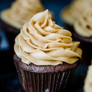 A display of chocolate cupcakes with peanut butter frosting.