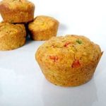 Corn muffins with peppers on a white plate.