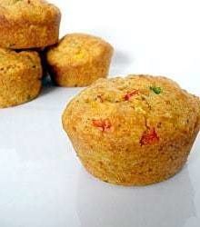 Corn muffins with peppers on a white plate.