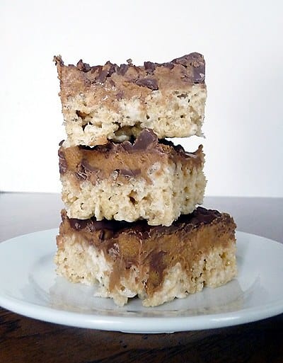 Stack of 3 peanut butter cup Rice Krispies treats on a white plate.