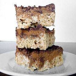 Stack of 3 peanut butter cup Rice Krispies treats on a white plate.