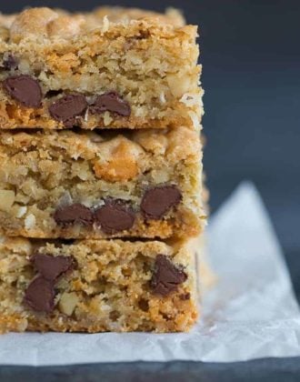 A big stack of chewy, chunky blondies with chocolate chips, butterscotch chips, walnuts and coconut.