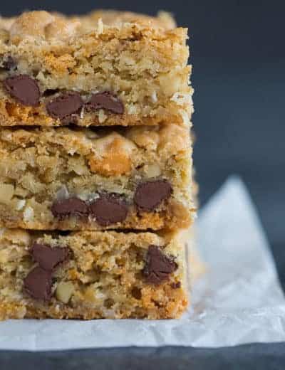 A big stack of chewy, chunky blondies with chocolate chips, butterscotch chips, walnuts and coconut.