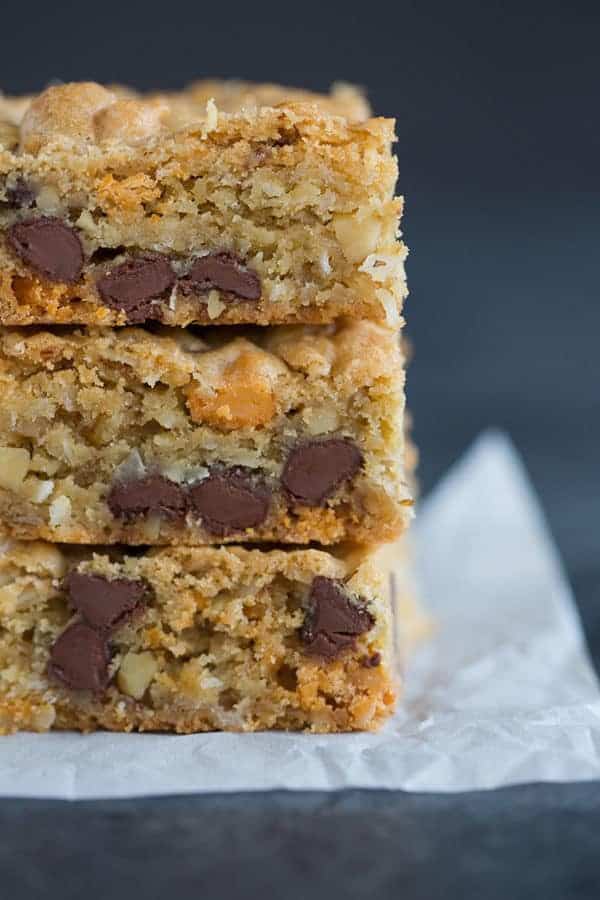 A big stack of chewy, chunky blondies with chocolate chips, butterscotch chips, walnuts and coconut.