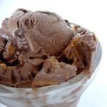 Scoops of chocolate fudge swirl peanut butter ice cream in a bowl.