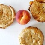 Overhead image of 3 peach pie tartlets.