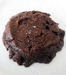A salted chocolate shortbread cookie on a white plate.