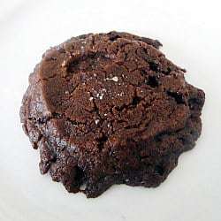 A salted chocolate shortbread cookie on a white plate.