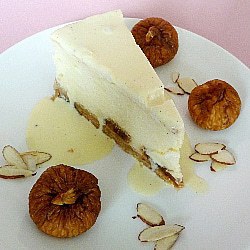 Slice of fig and almond cheesecake on a white plate.
