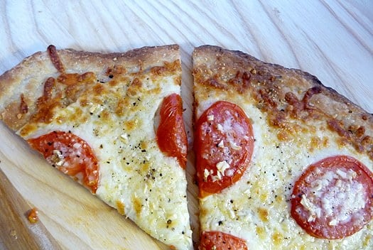 2 slices of white Sicilian pizza on a wood surface.