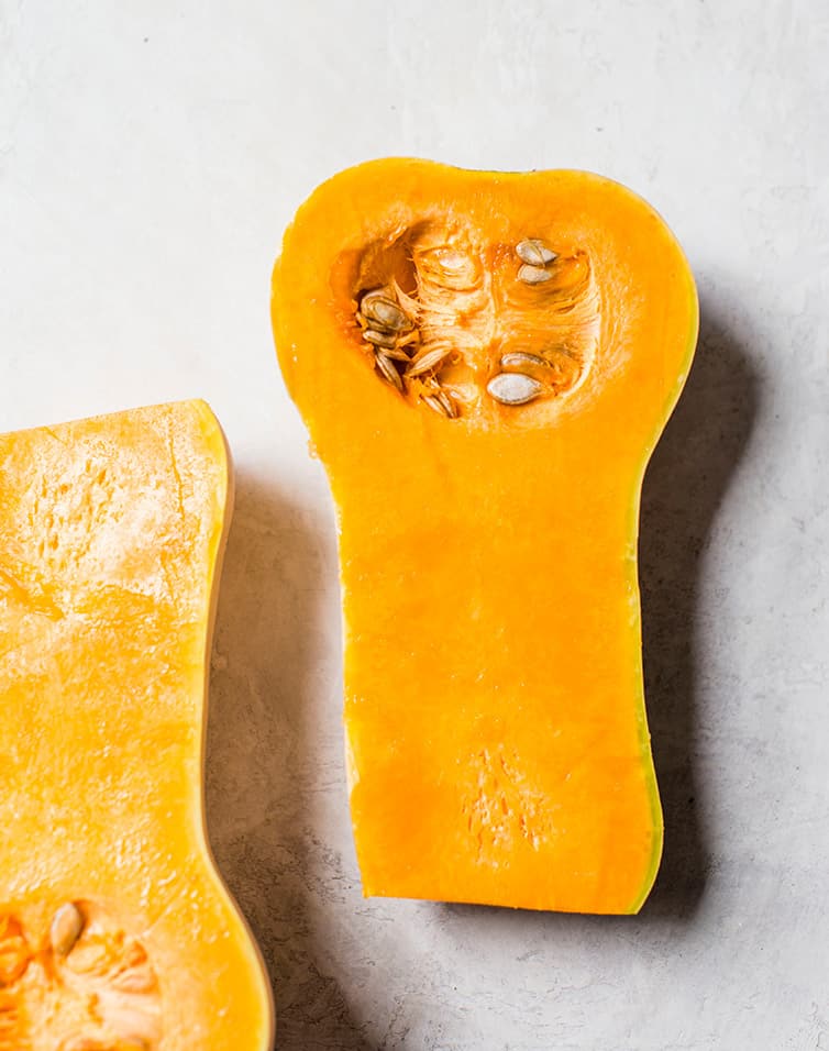 A butternut squash halved lengthwise.